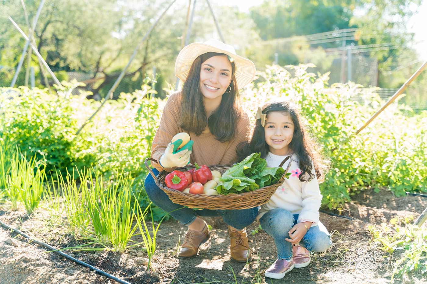 mom and daughter with a garden harvest