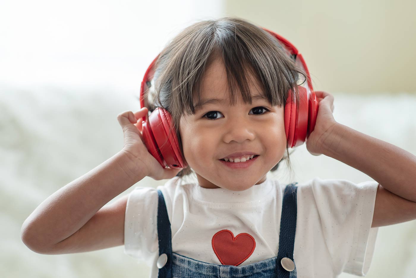 Happy child listening to music on headphones