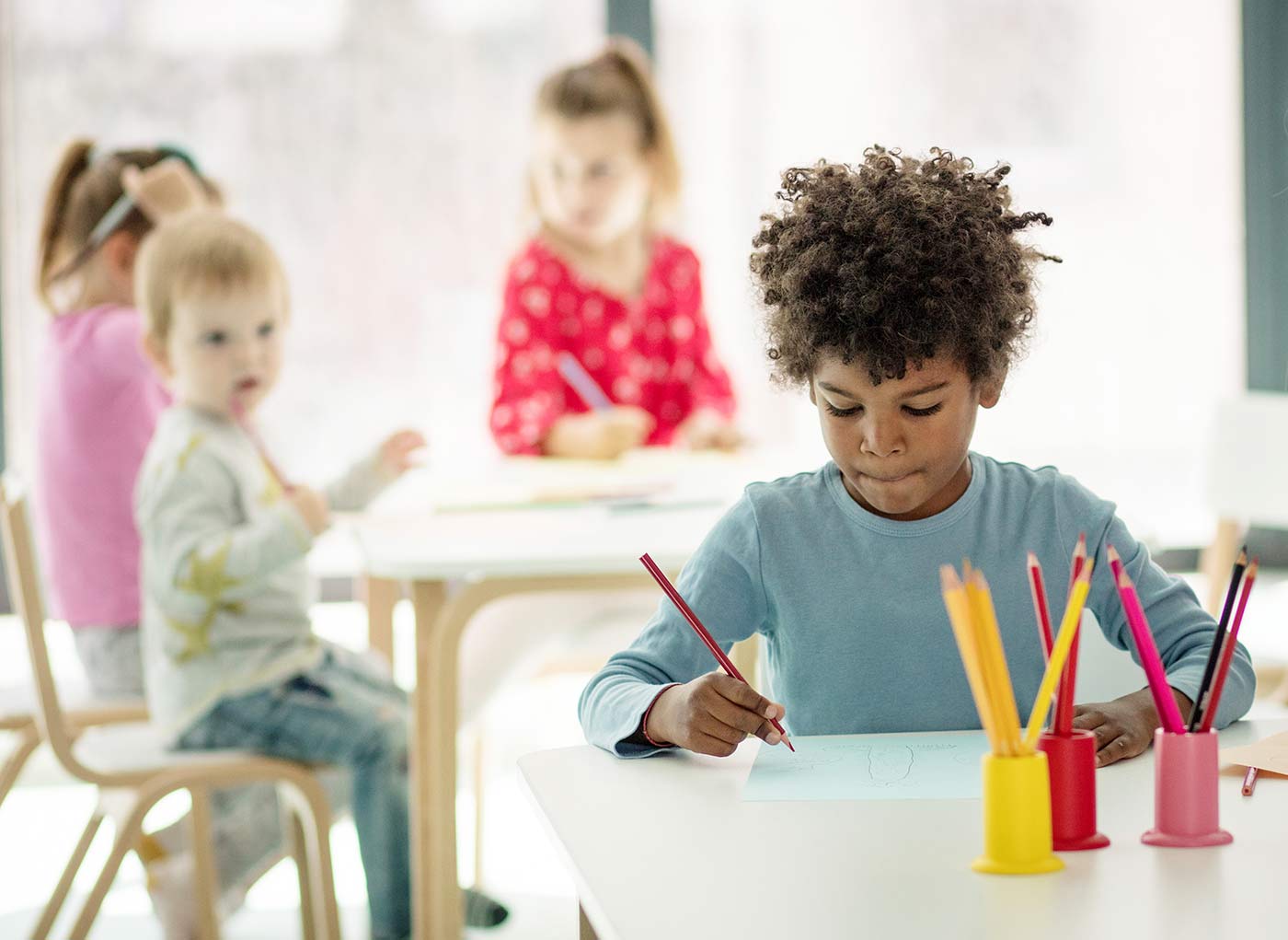 Little boy writing in school