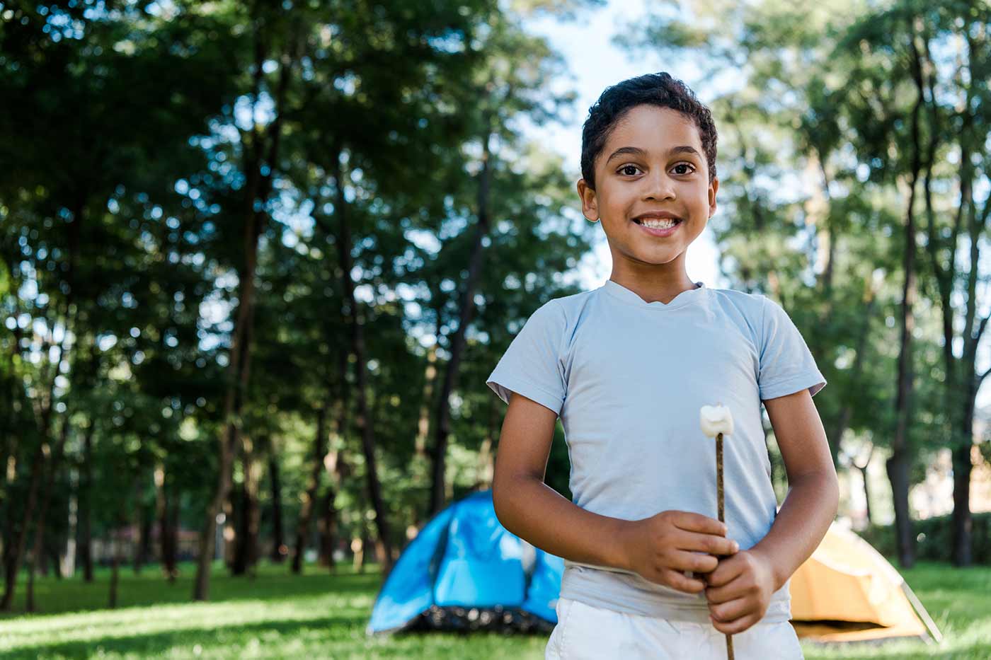 boy holding a marshmallow for summer camp